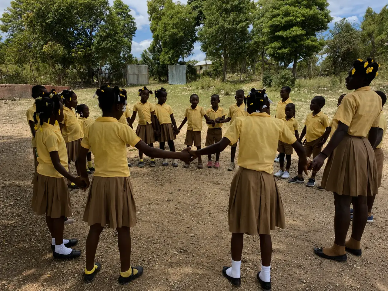 Children in the mountains of southern Haiti holding hands in a circle