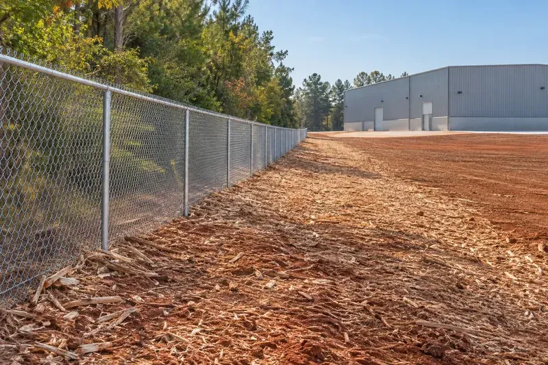 Freshly mulched ground along a property boundary