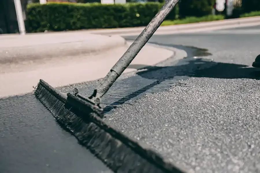 Sealcoat being applied to an asphalt surface