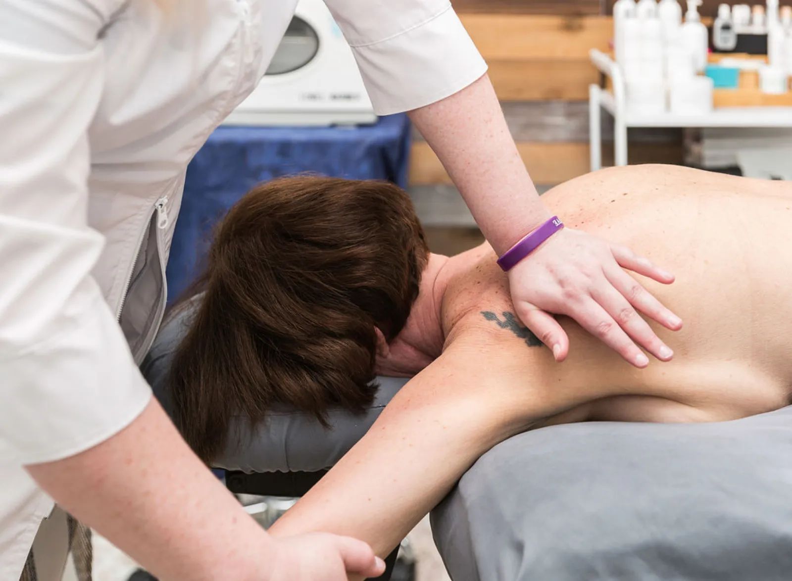 Therapist working on a client's shoulder at Piedmont Injury Massage in Hoschton, GA