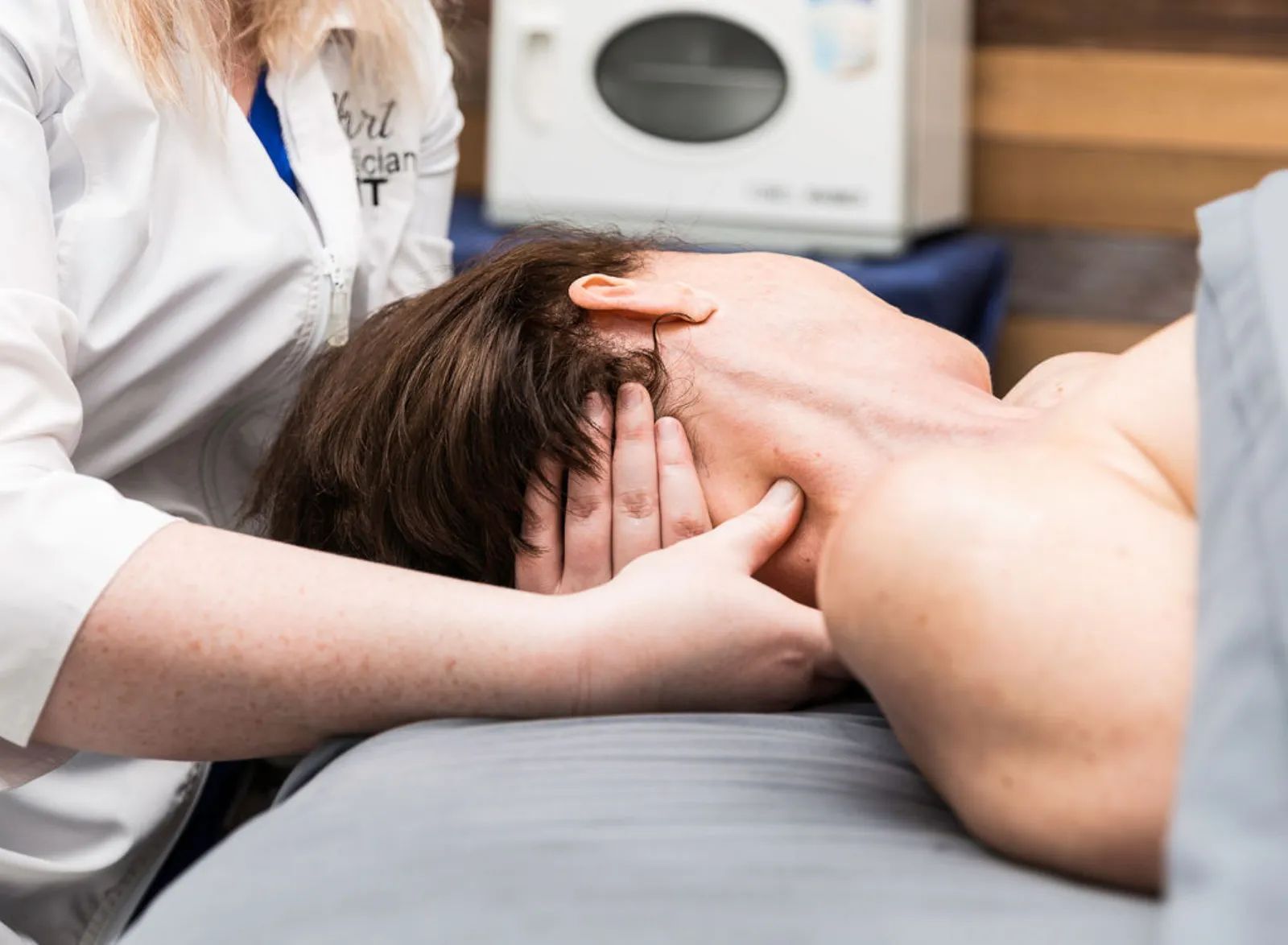 Therapist supporting a client's head and neck at Piedmont Injury Massage in Hoschton, GA
