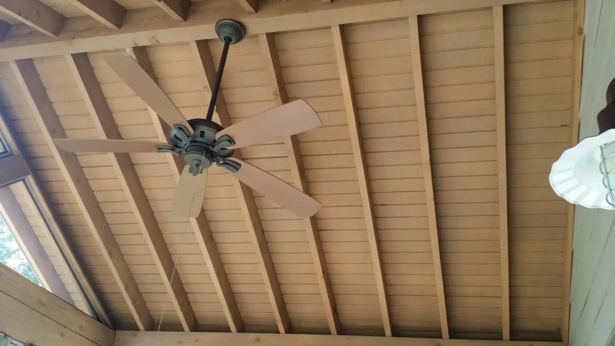 Exposed ceiling beams and fan inside a pavilion