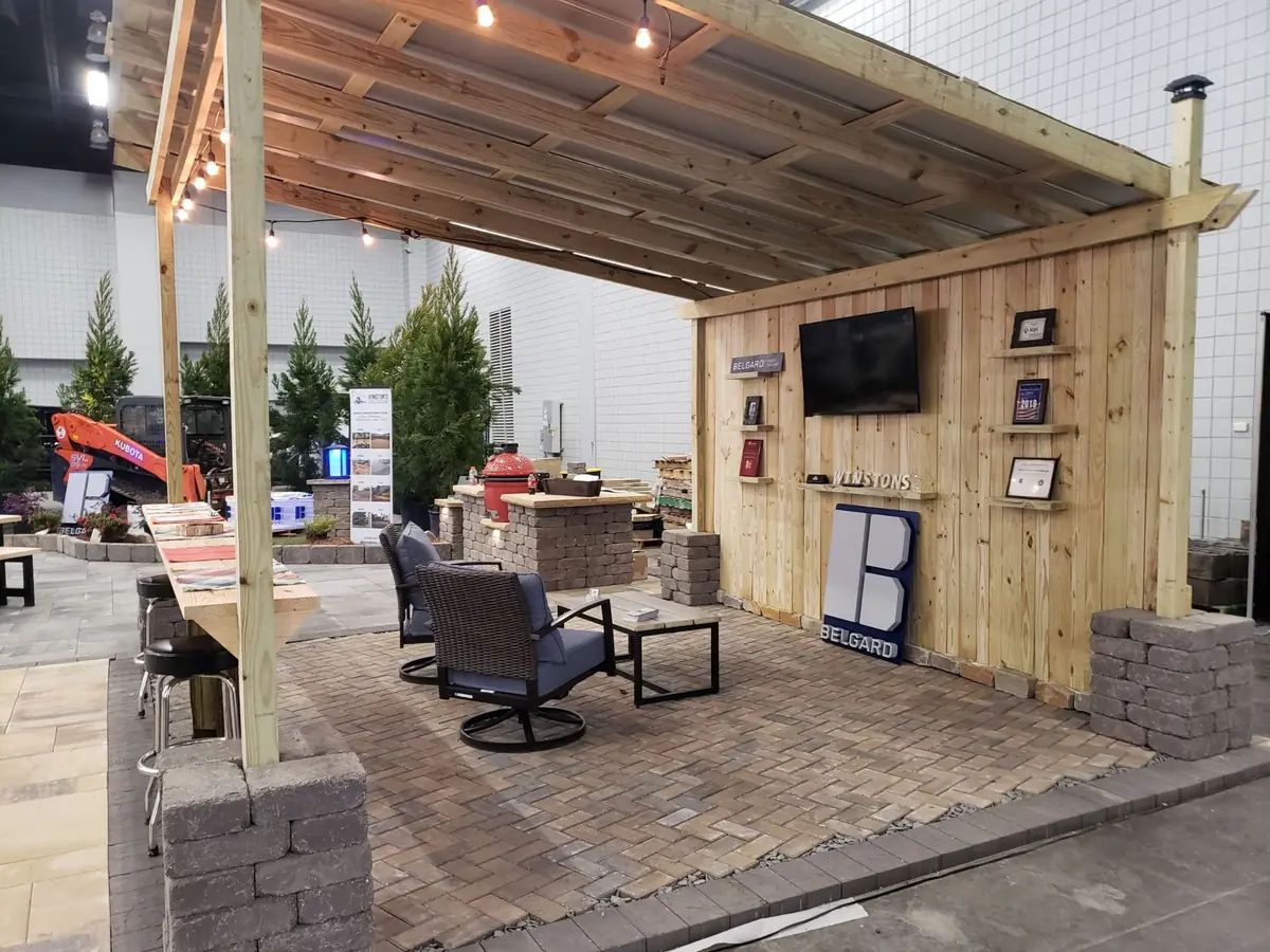 Covered outdoor sitting area with stone columns and wood ceiling
