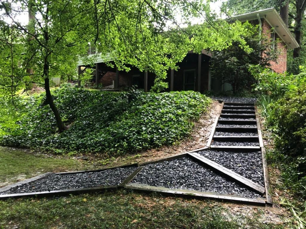 Stone steps and a winding garden walkway through established landscaping