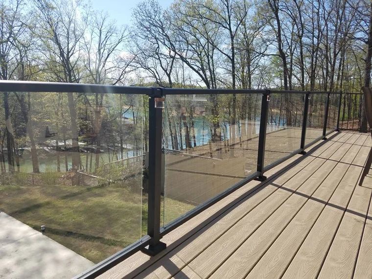 Wood deck with black railings overlooking the lake