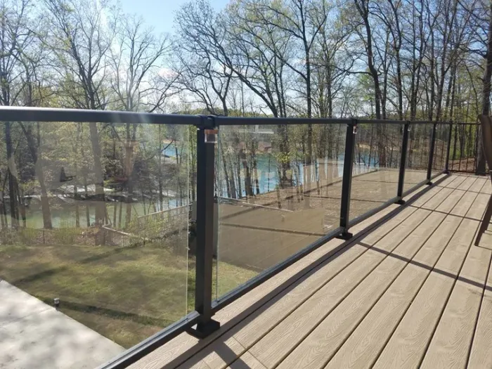 Wood deck with black railings overlooking the lake