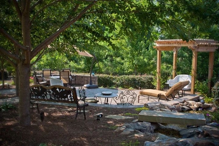 Shaded garden patio with outdoor dining and timber pergola seating