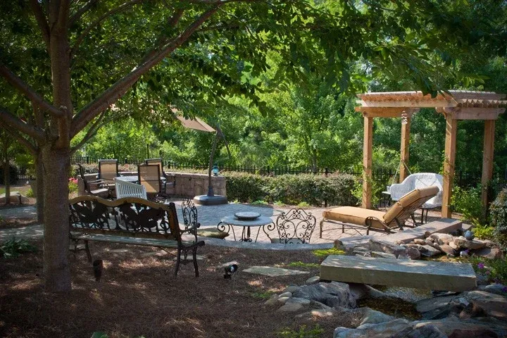 Shaded garden patio with outdoor dining and timber pergola seating