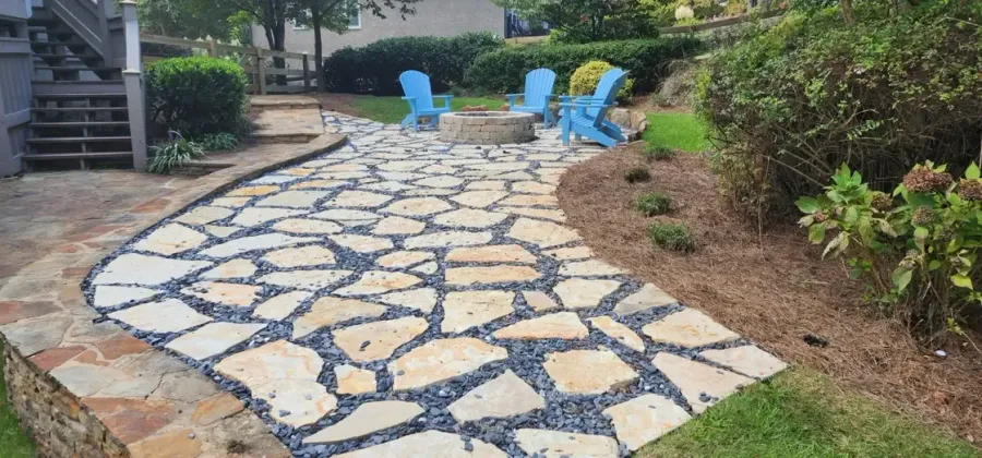 Wide flagstone walkway connecting the house to backyard seating