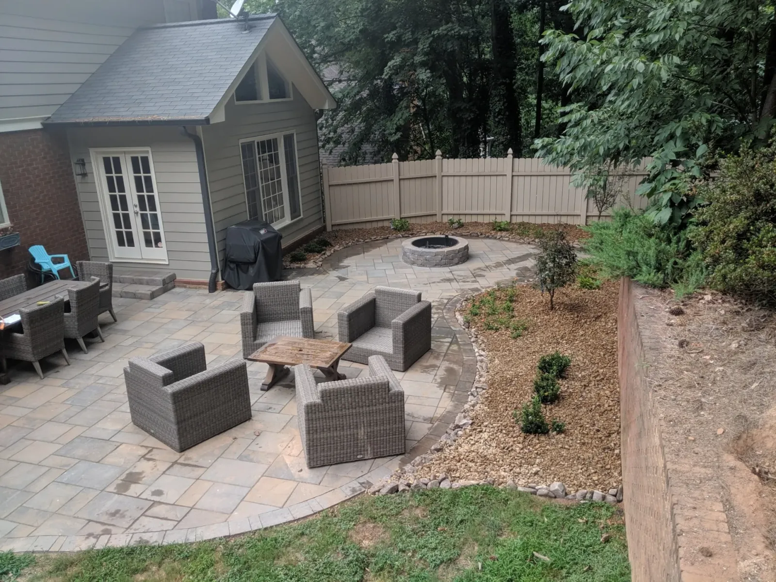 Furnished paver patio with an outdoor dining area and stone fire pit