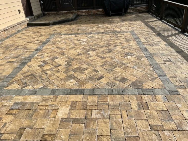 Herringbone paver patio framed by a contrasting border