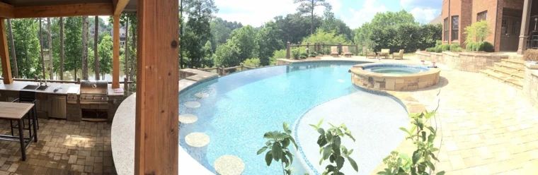 Swimming pool and raised spa beside a shaded outdoor living area