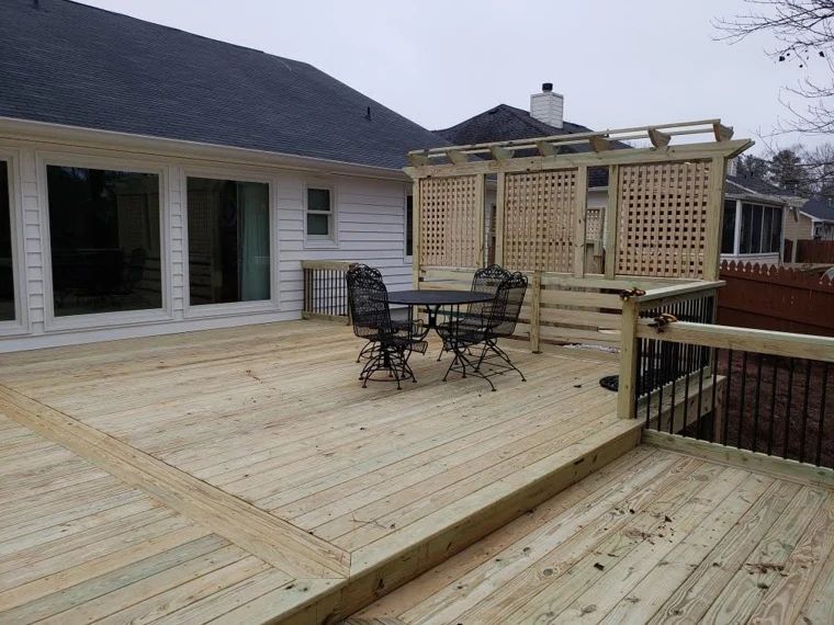 Wood deck with wide steps, privacy lattice, and outdoor dining furniture