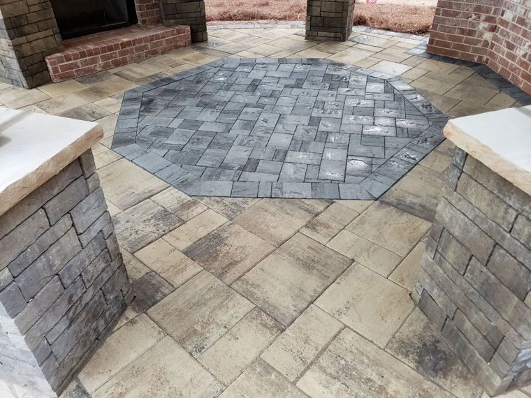 Patterned paver patio with contrasting borders and stone steps