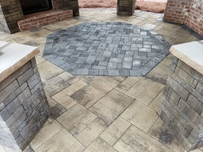 Patterned paver patio with contrasting borders and stone steps