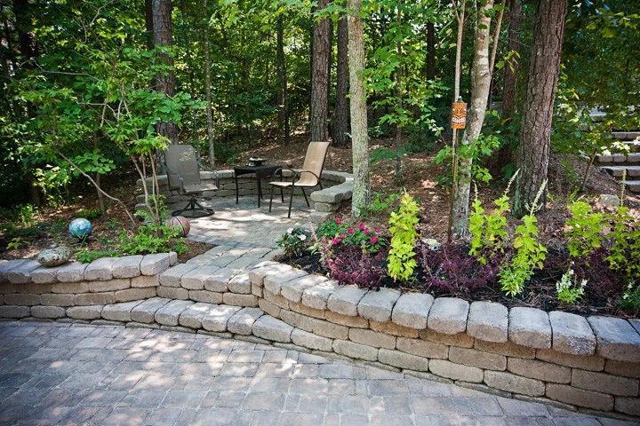 Stone garden walls and steps surrounded by flowering perennials