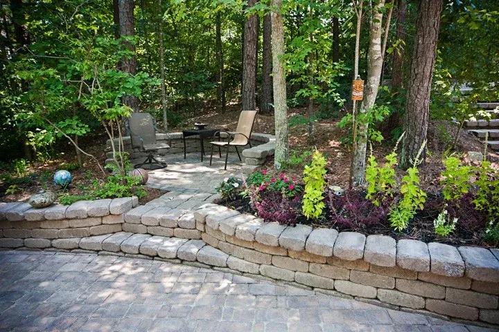 Stone garden walls and steps surrounded by flowering perennials