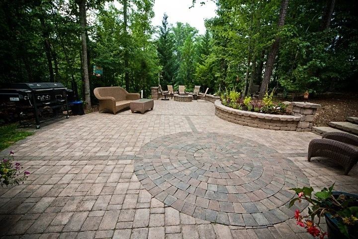 Paver patio with outdoor seating, dining furniture, and curved planting beds