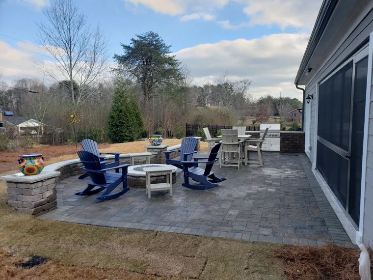 Furnished paver patio with a fire pit and outdoor dining area