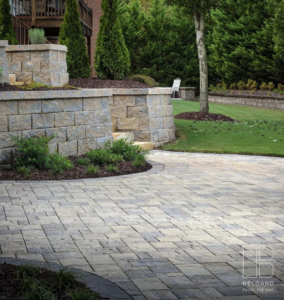 Stone garden walls and a paver terrace with mature planting