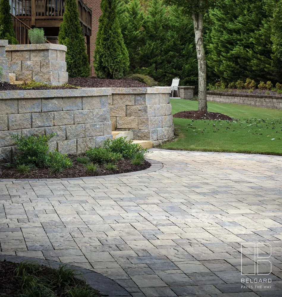 Stone garden walls and a paver terrace with mature planting