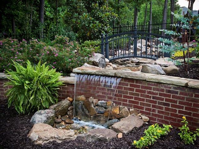 Brick garden water feature with natural stone and ferns