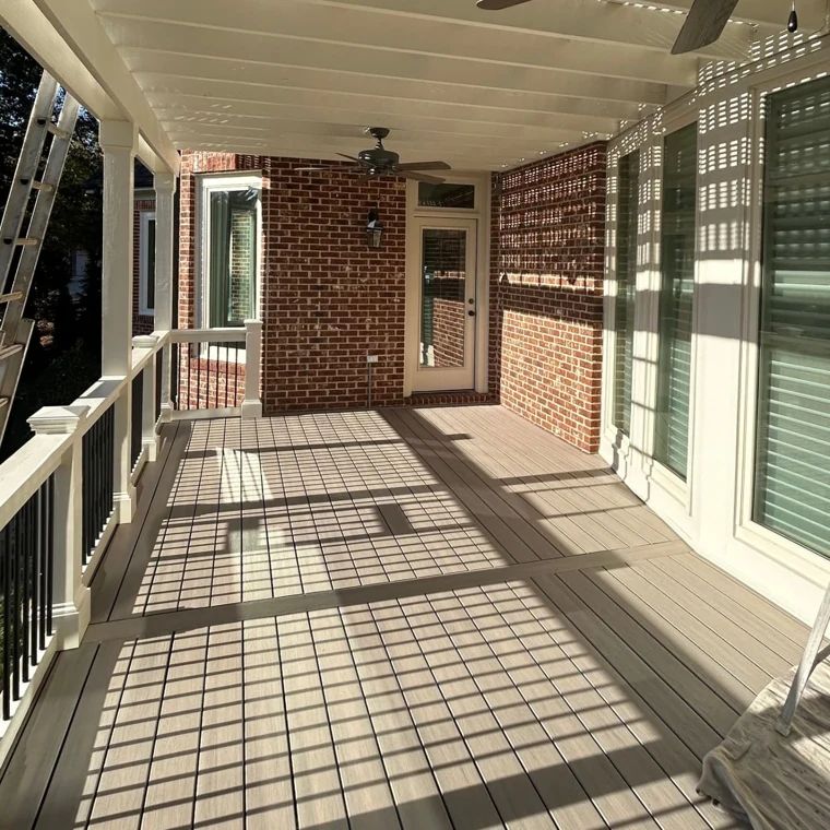 Covered deck with composite flooring and white railings