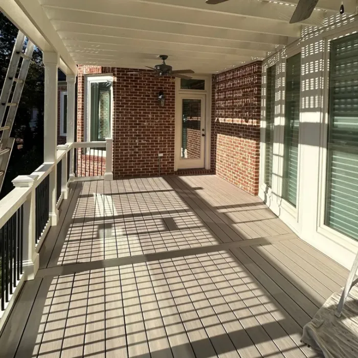 Covered deck with composite flooring and white railings