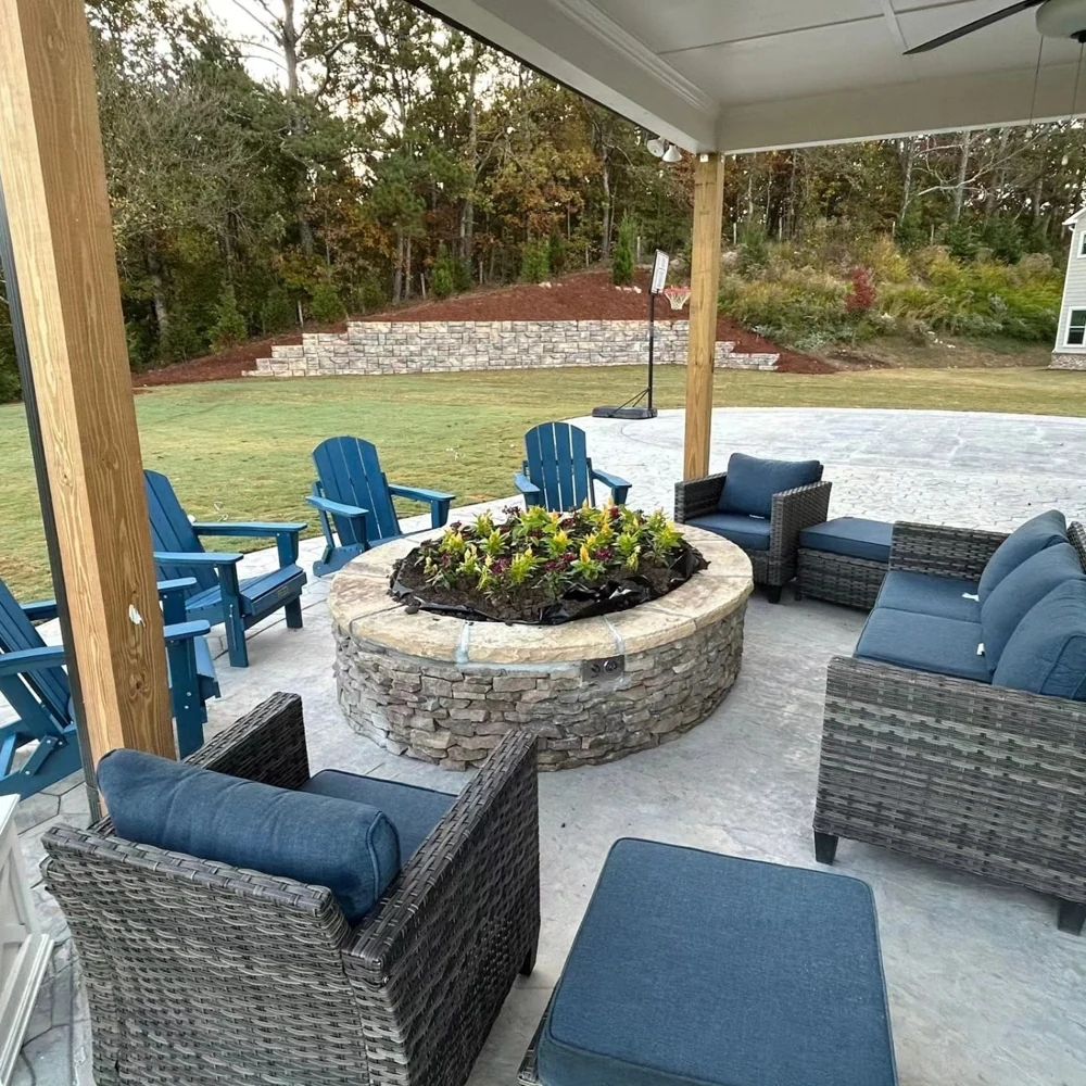 Covered patio with lounge seating around a circular stone planter