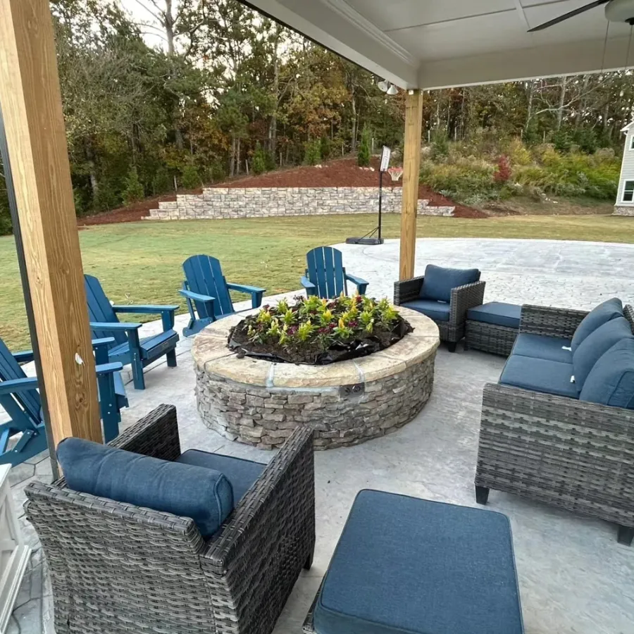 Covered patio with lounge seating around a circular stone planter