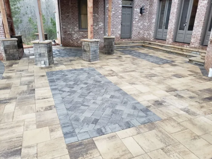 Patterned paver patio with stone steps and contrasting borders