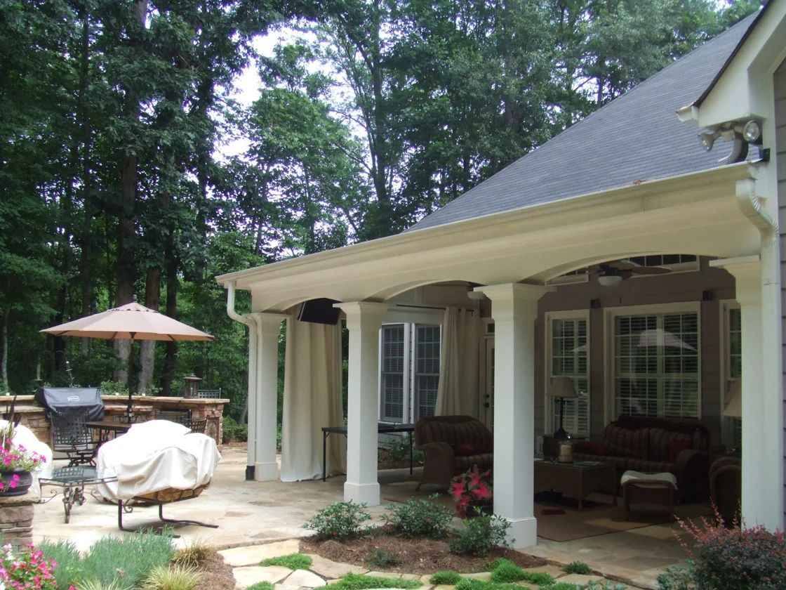 Covered patio and outdoor dining area surrounded by garden planting