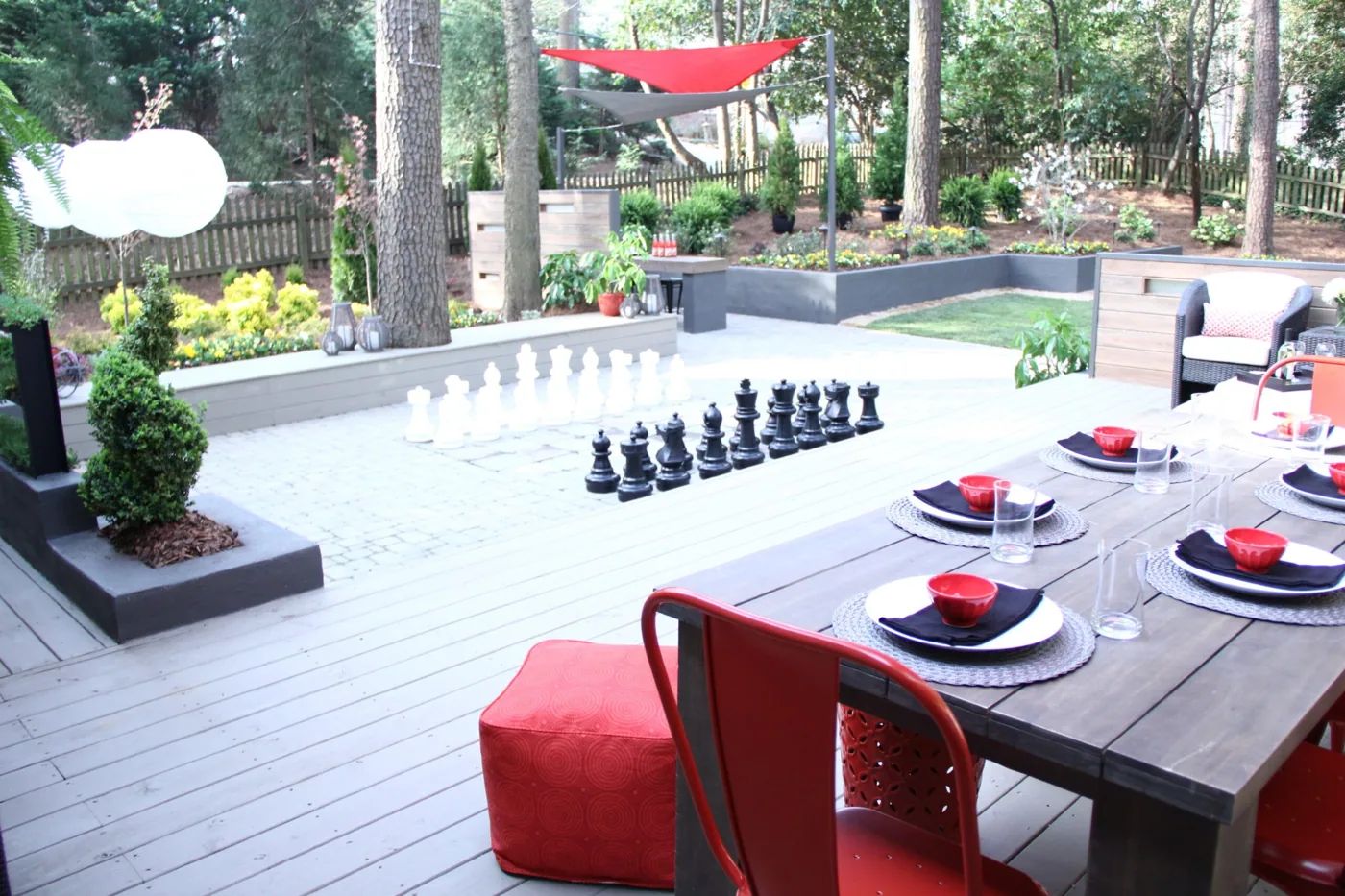 Composite deck arranged for outdoor dining in a landscaped backyard