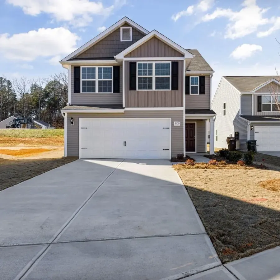New concrete driveway at a two-story home