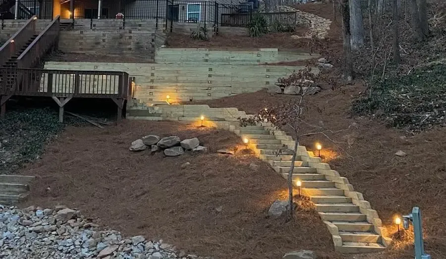 Illuminated stairs on a wooded hillside