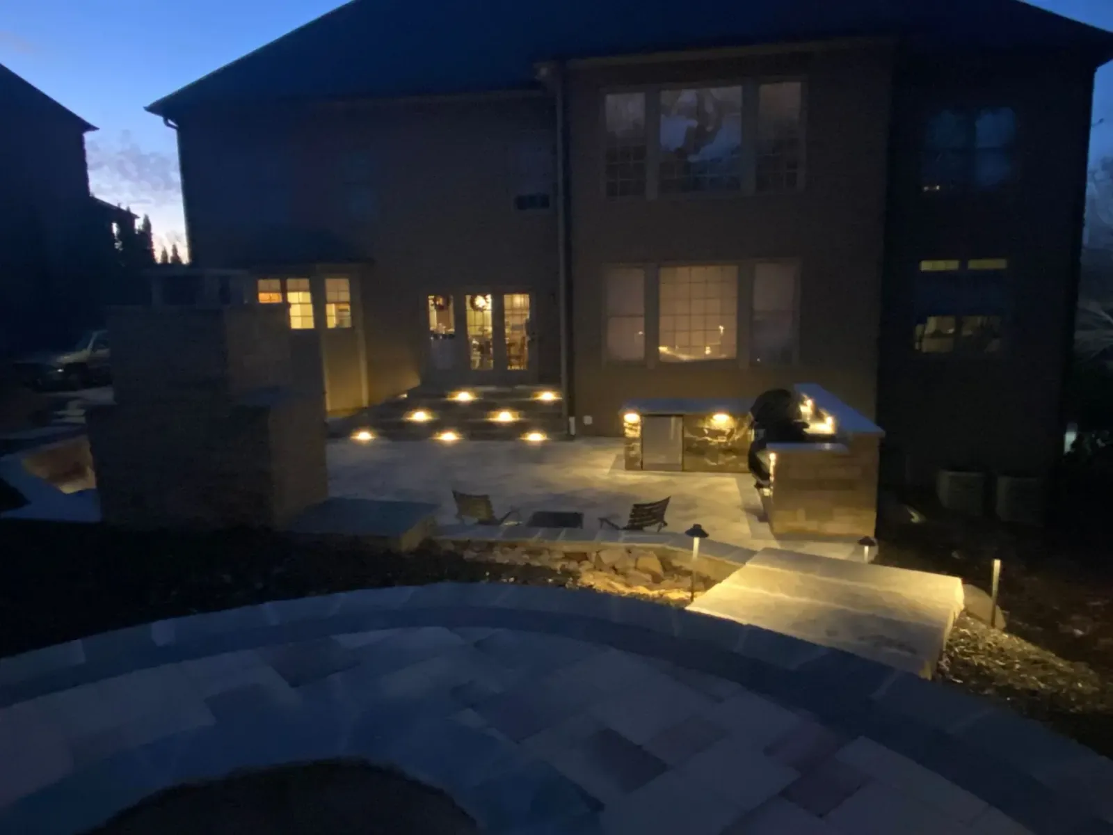 Illuminated patio outside a home after sunset