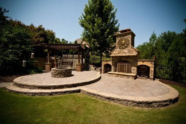 Stone outdoor fireplace with a curved terrace