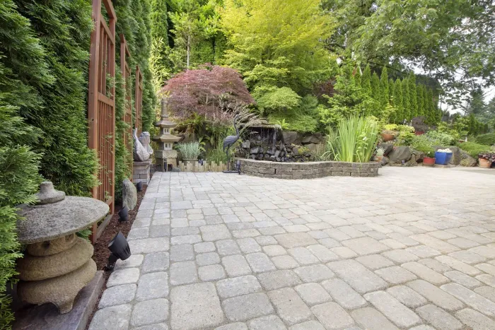 Finished paver patio bordered by established planting