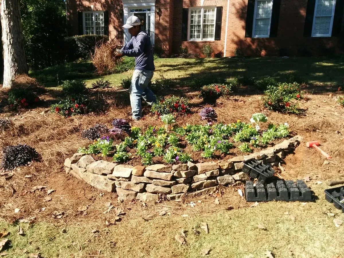 Planting bed installation beside a brick home