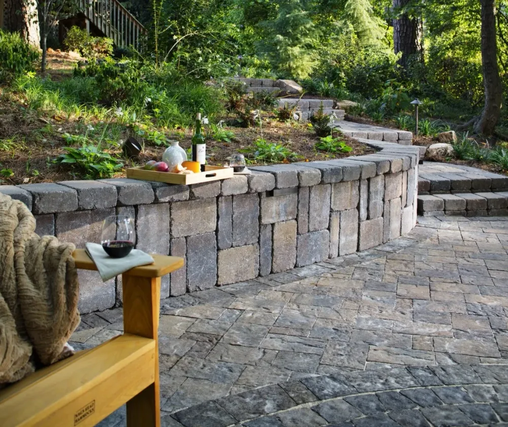 Finished stone walkway and garden steps beside a curved masonry wall