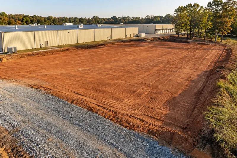 Prepared commercial ground with retained vegetation and site infrastructure