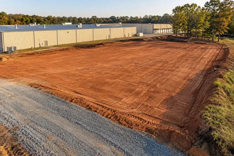 Prepared commercial ground with retained vegetation and site infrastructure