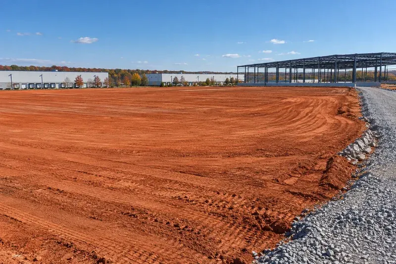 Prepared commercial ground with retained vegetation and site infrastructure
