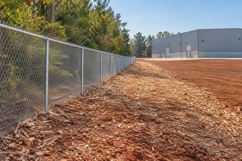 Freshly mulched ground along a property boundary