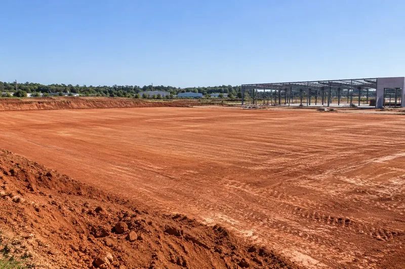 Prepared commercial ground with retained vegetation and site infrastructure