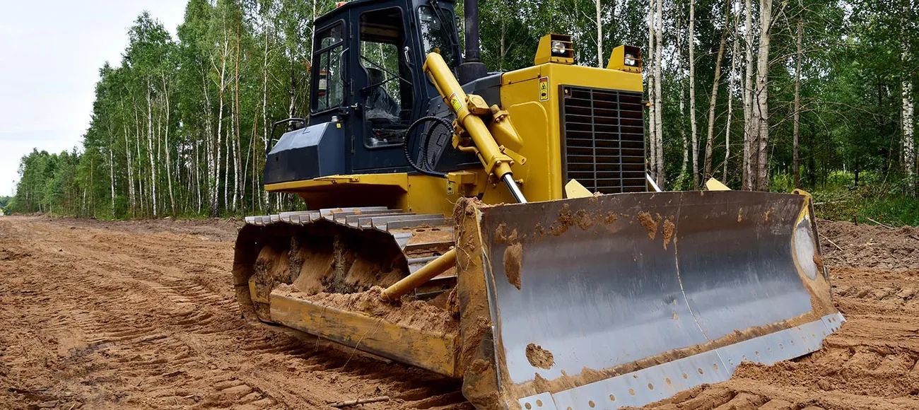 Yellow bulldozer preparing a graded construction site