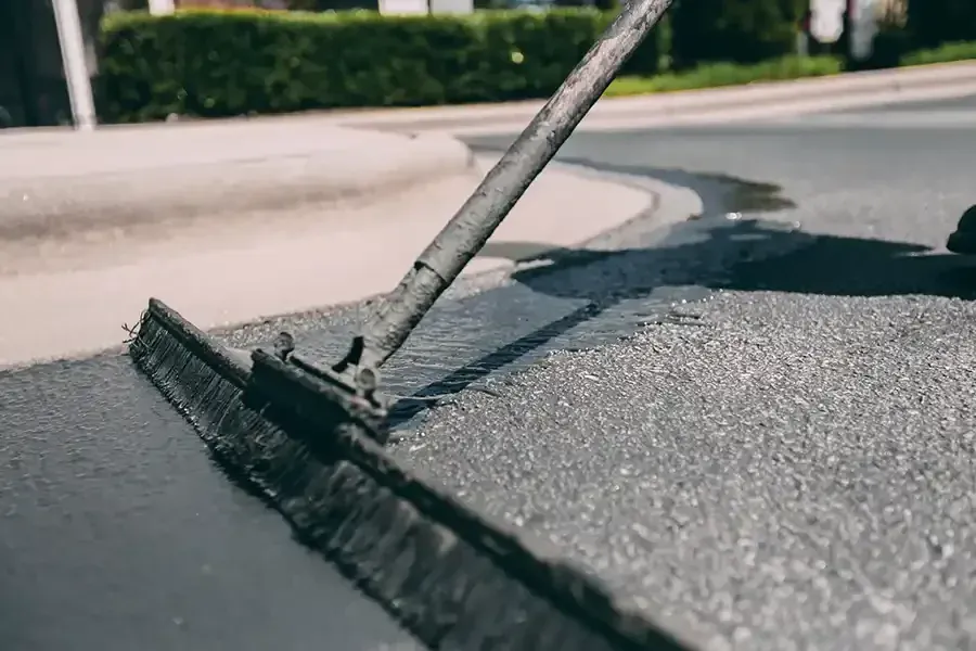 Sealcoat being applied to an asphalt surface